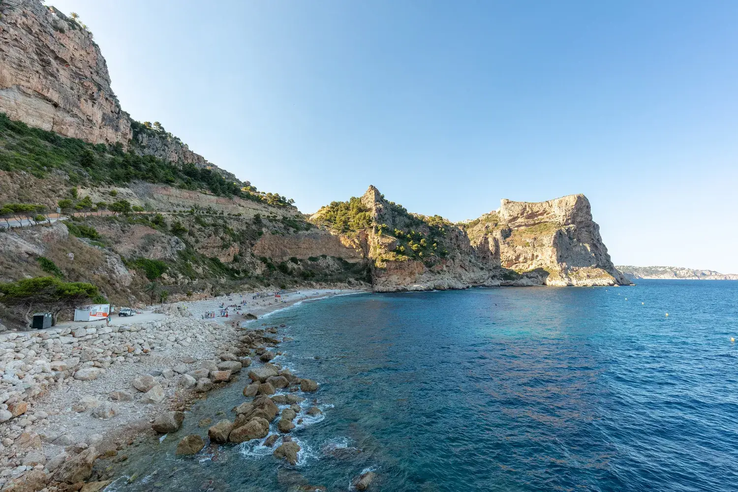 Cala del Moraig, a pebble cove below high cliffs with turquoise water