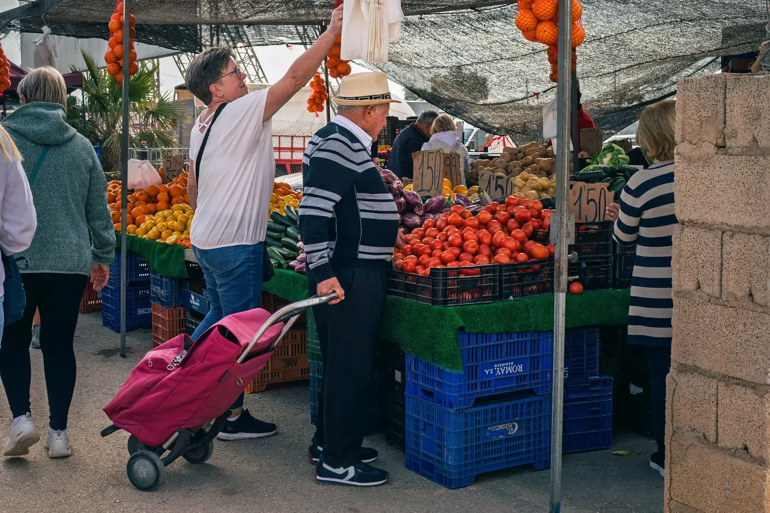 Clients faisant leurs courses entre les étals du marché hebdomadaire de Guardamar
