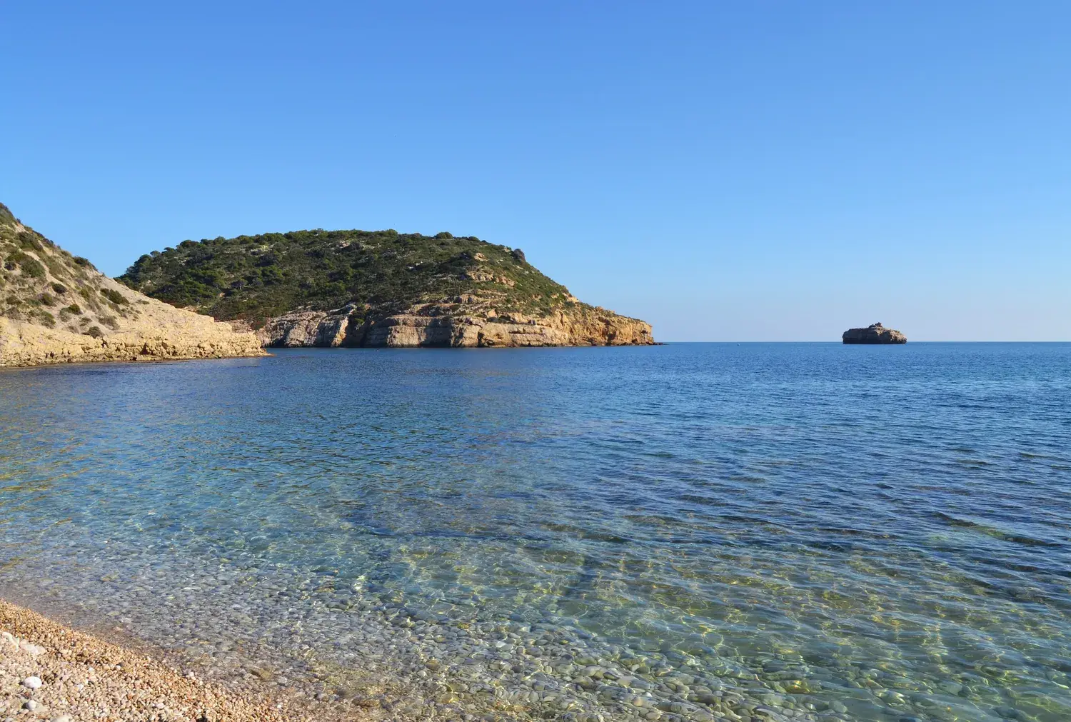 Portitxol island opposite La Barraca cove in Xàbia, calm and clear sea